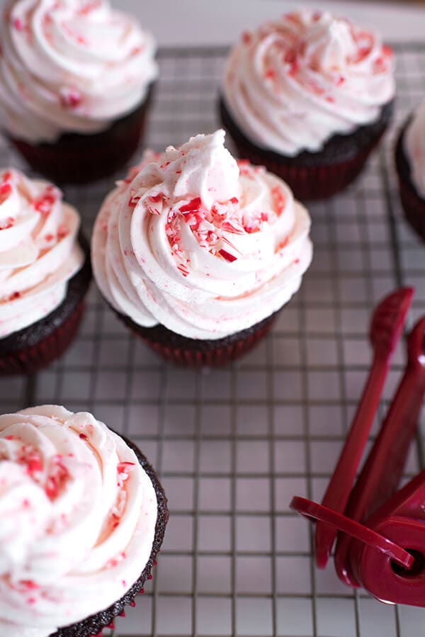 Chocolate Cupcakes with Peppermint Buttercream Frosting on a cooling rack