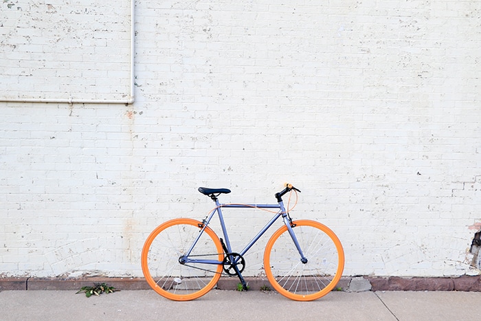 How to Make Bike Seat More Comfortable and Your Butt Hurt Less After Spin Class - bike against brick wall