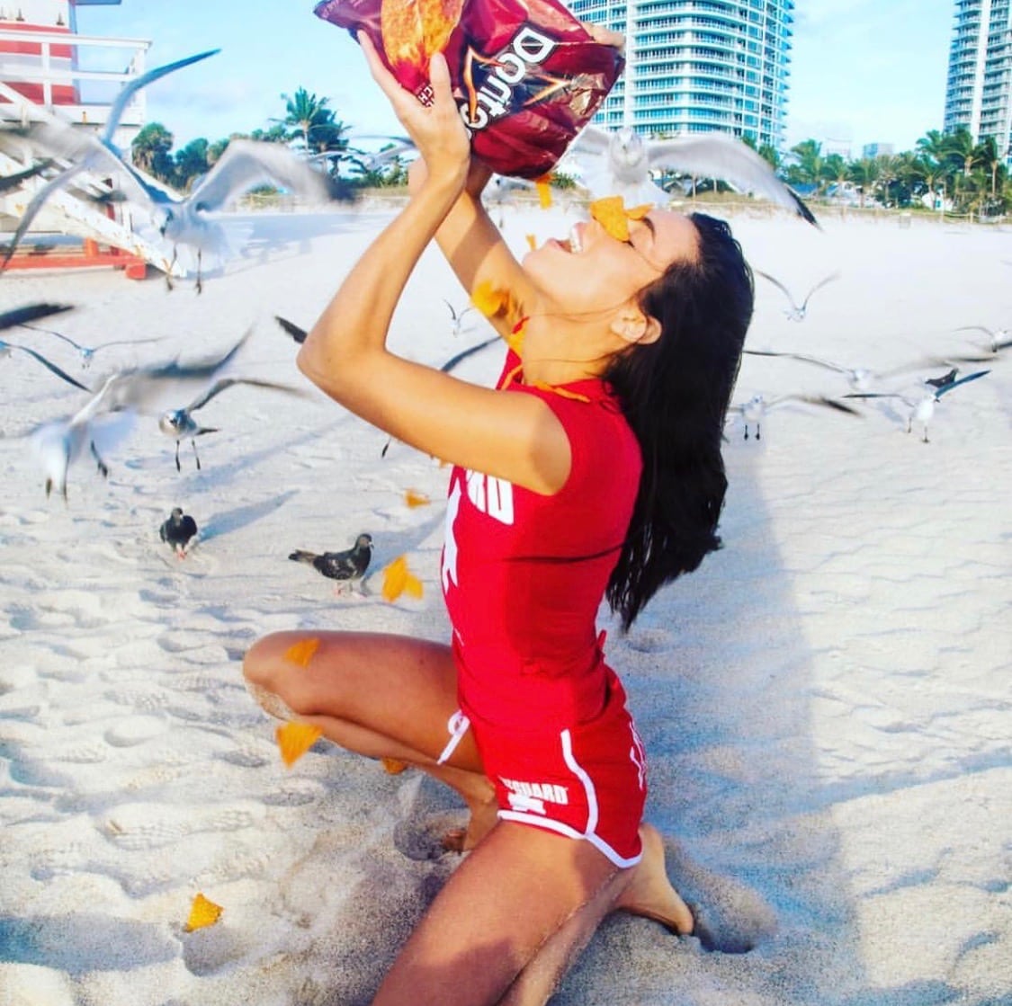 Liz Plank Engagement Shoot with a Bag of Doritos - pouring bag on face on beach