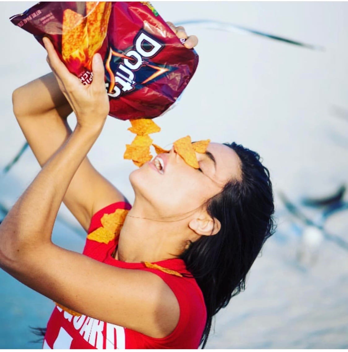 Liz Plank Engagement Shoot with a Bag of Doritos - closeup of pouring bag on face