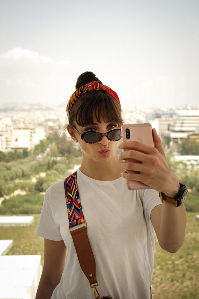 how to take your own passport photos - woman taking selfie