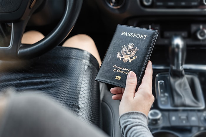 Woman Driving Holding Passport