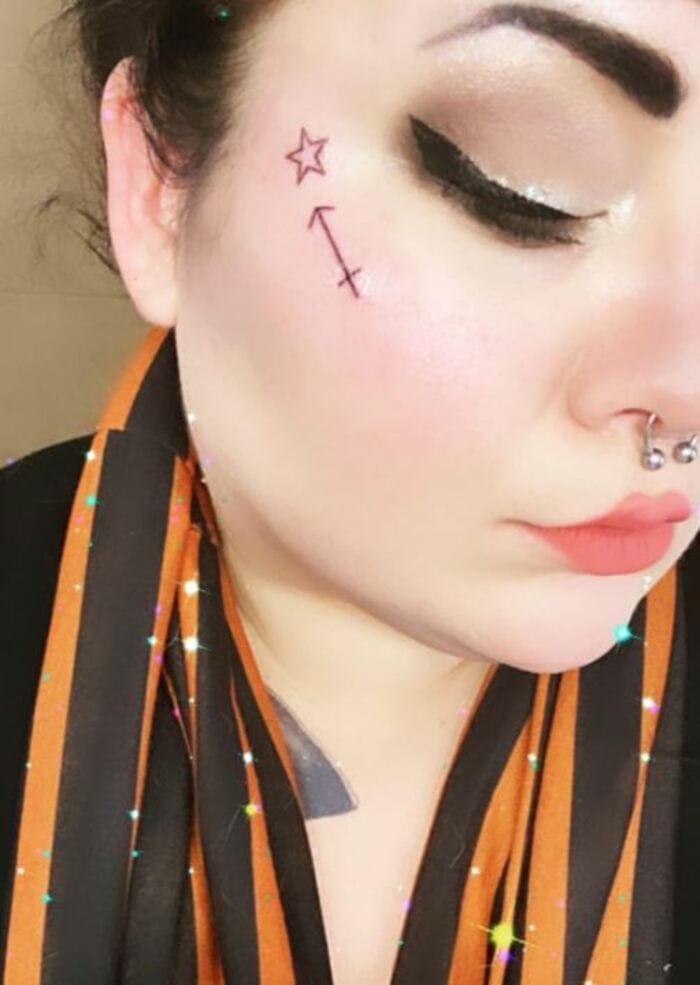 Sagittarius Tattoos - Delicate arrow and star under eye