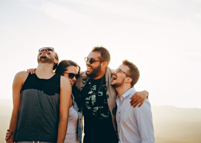 Knock Knock Jokes - group of friends laughing on beach
