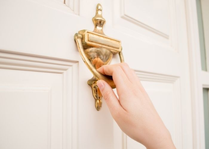Knock Knock Jokes - gold door knocker with hand