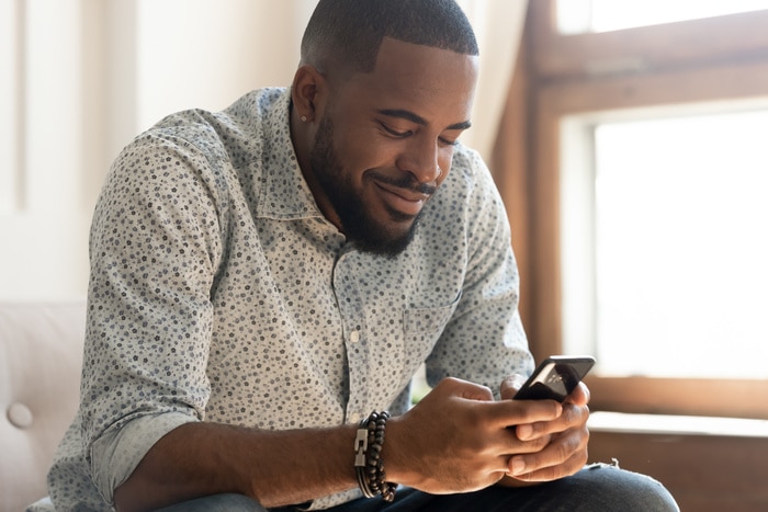 Signs You're Dating a Fuckboy - Guy looking at phone