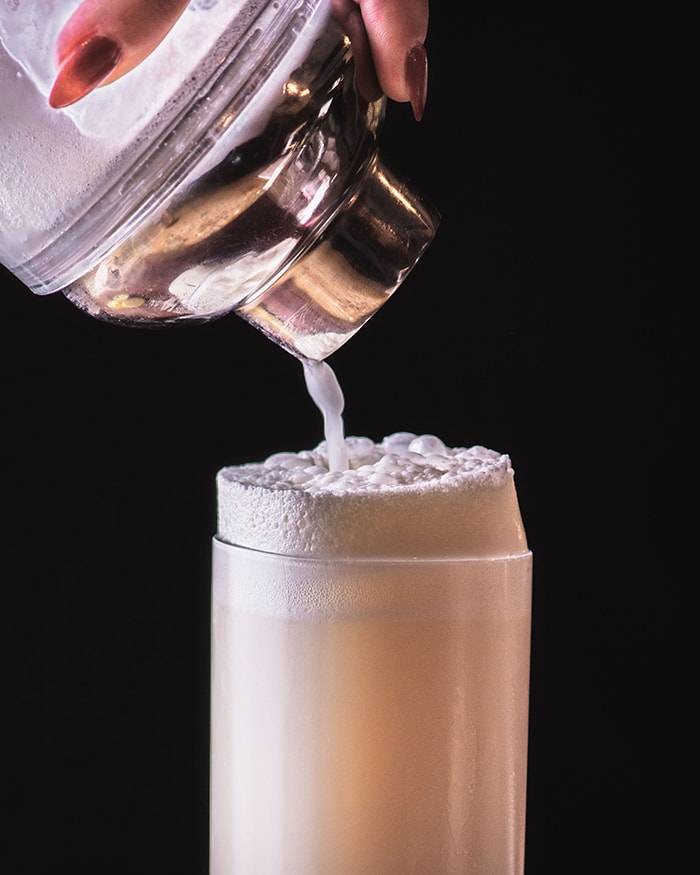 Ramos Gin Fizz - pouring from cocktail shaker