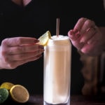 Ramos Gin Fizz - bartender placing lemon wedge