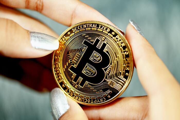 Crypto Mistakes - woman holding bitcoin