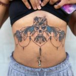 underboob tattoo - skull and flowers