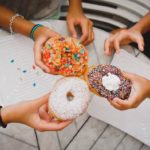 Donut Facts - friends sharing doughnuts