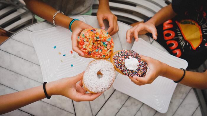 Donut Facts - friends sharing doughnuts