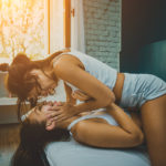 Best Sex Tips - lesbian couple laughing in bed
