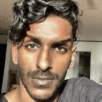 Nose Piercing Men - curly hair guy with mustache
