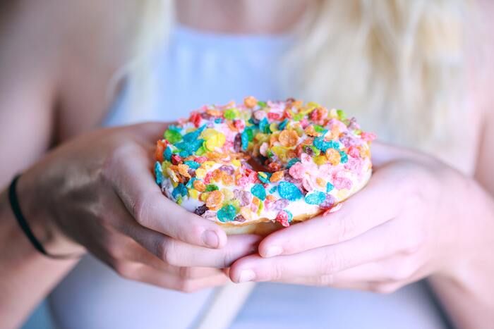 Doughnut or Donut - woman holding donut