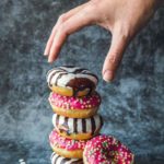 Doughnut or Donut - person picking up donuts