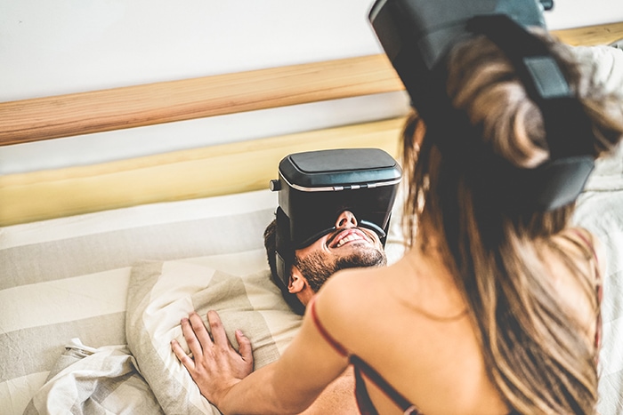 Sex and Porn in the Metaverse - Couple In Bed Wearing VR Goggles