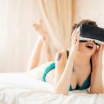 Sex and Porn in the Metaverse - Woman In Bed Wearing VR Goggles