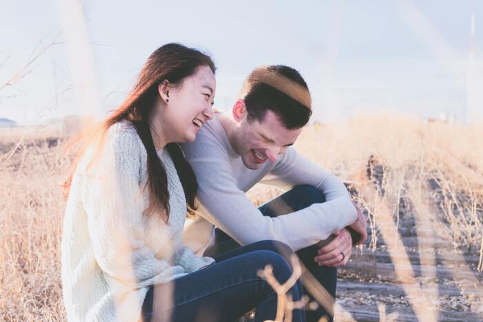 Adult Jokes - couple laughing on beach