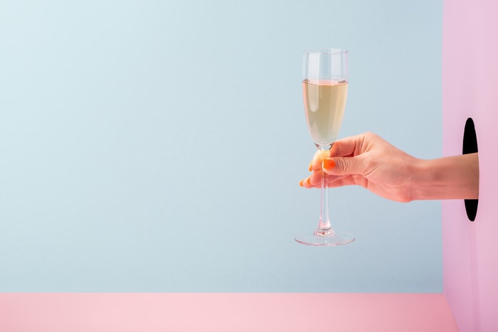 Negroni Sbagliato with Proescco Recipe - Woman's Hand Holding Champagne Flute