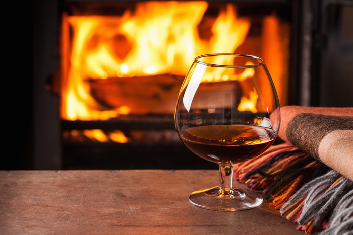 Best Cognac Brands - Snifter in front of Fireplance