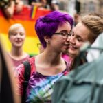 Difference between bisexual and pansexual - couple kissing at pride
