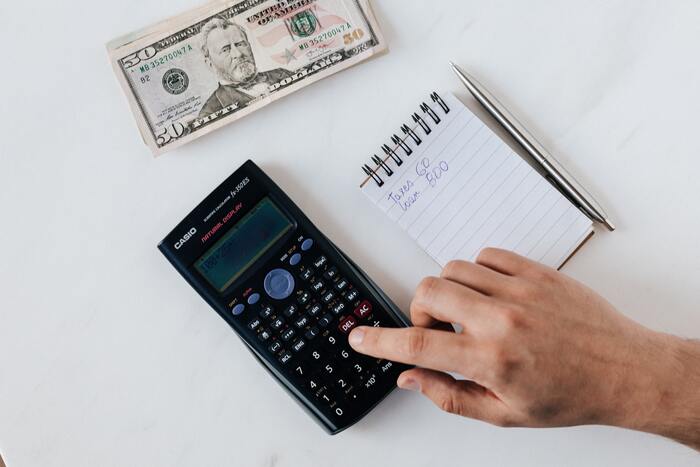 How to Stop Spending Money - person budgeting