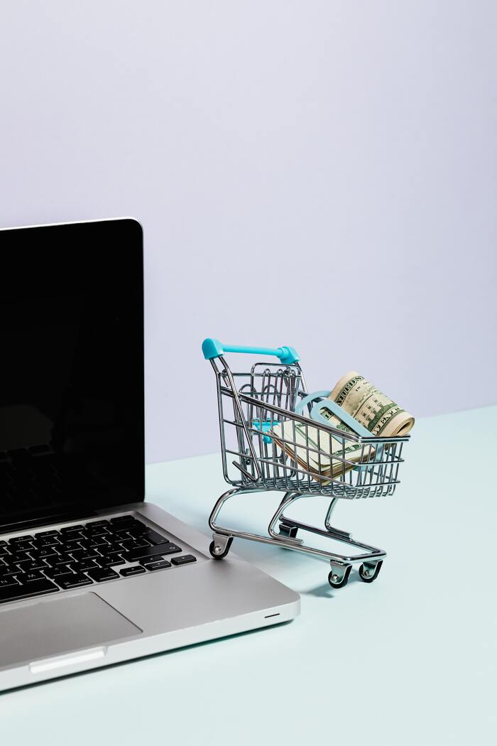 How to Stop Spending Money - mini shopping cart with cash inside