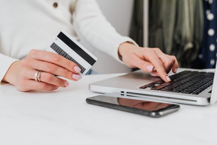 How to Stop Spending Money - credit card next to computer