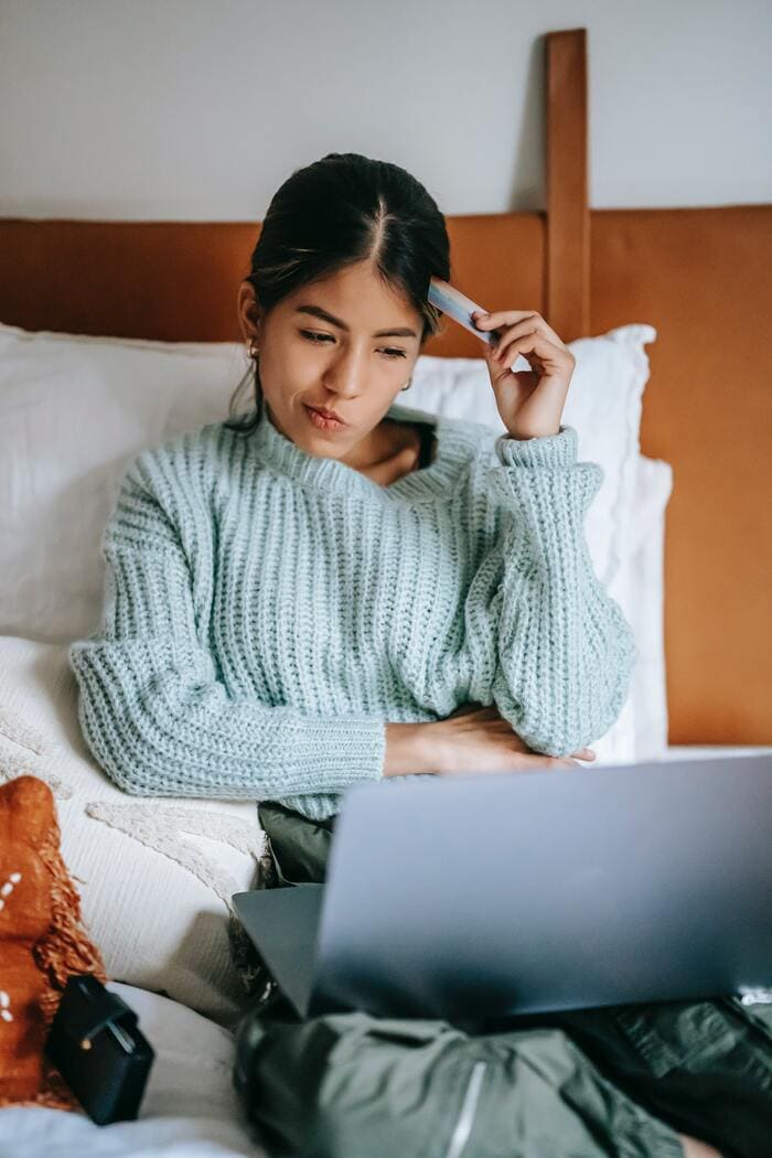 How to Stop Spending Money - woman considering a purchase