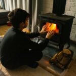 Fun winter activities- kid in front of fireplace