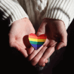Polycule meaning- hands holding rainbow heart