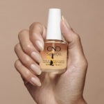 Hand holding CND Solar Oil