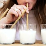 Pistachio milk vs almond milk- woman drinking milk