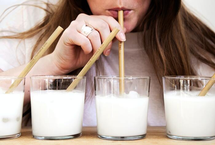 Pistachio milk vs almond milk- woman drinking milk