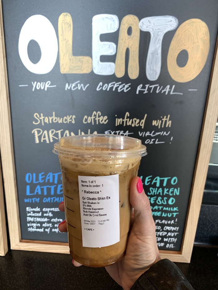 Starbucks Secret Menu Oleato Drinks - holding shaken oleato espresso with oleato sign