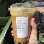 Starbucks Secret Menu Oleato Drinks - holding drink palm tree