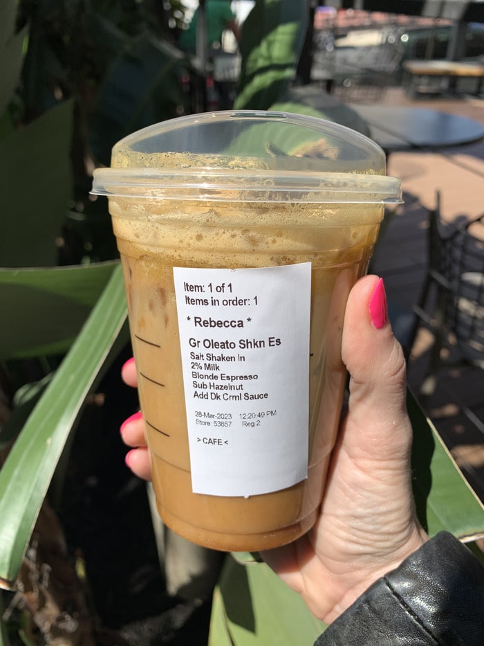 Starbucks Secret Menu Oleato Drinks - holding drink palm tree
