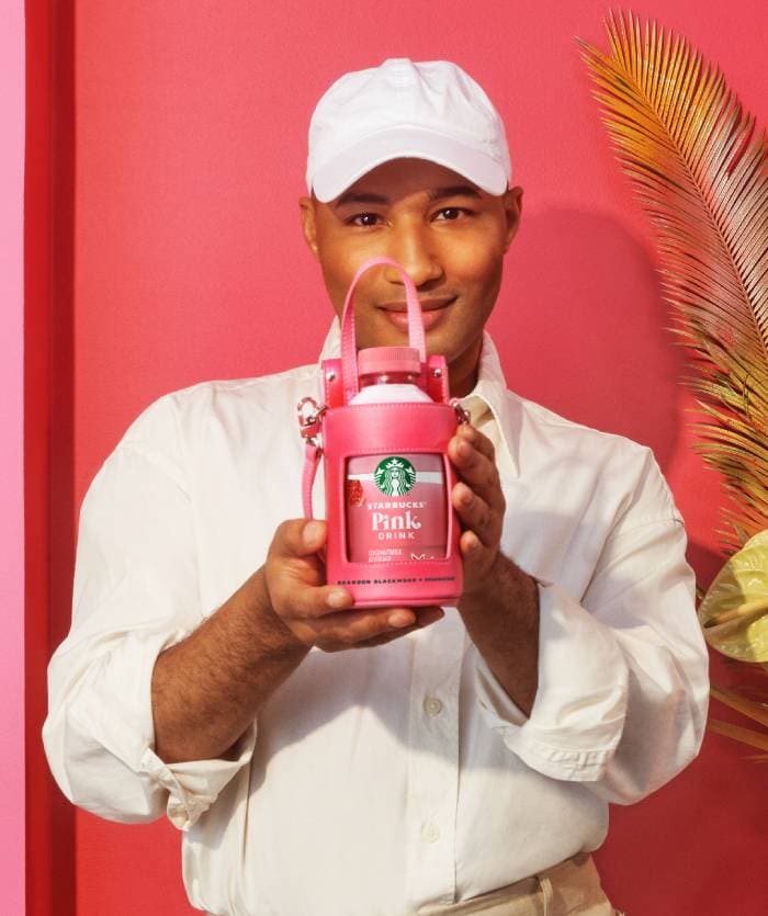 Brandon Blackwood Starbucks Sip and Sling Bottle Bag - holding pink bag