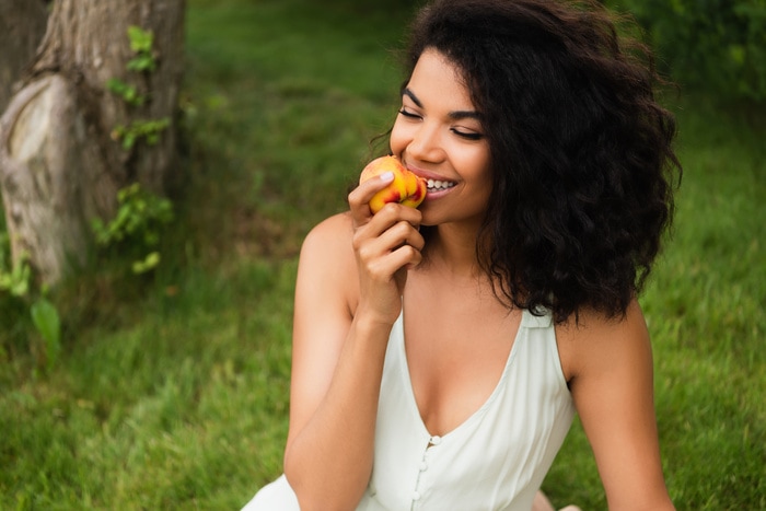 Peach Puns - woman eating nectarine