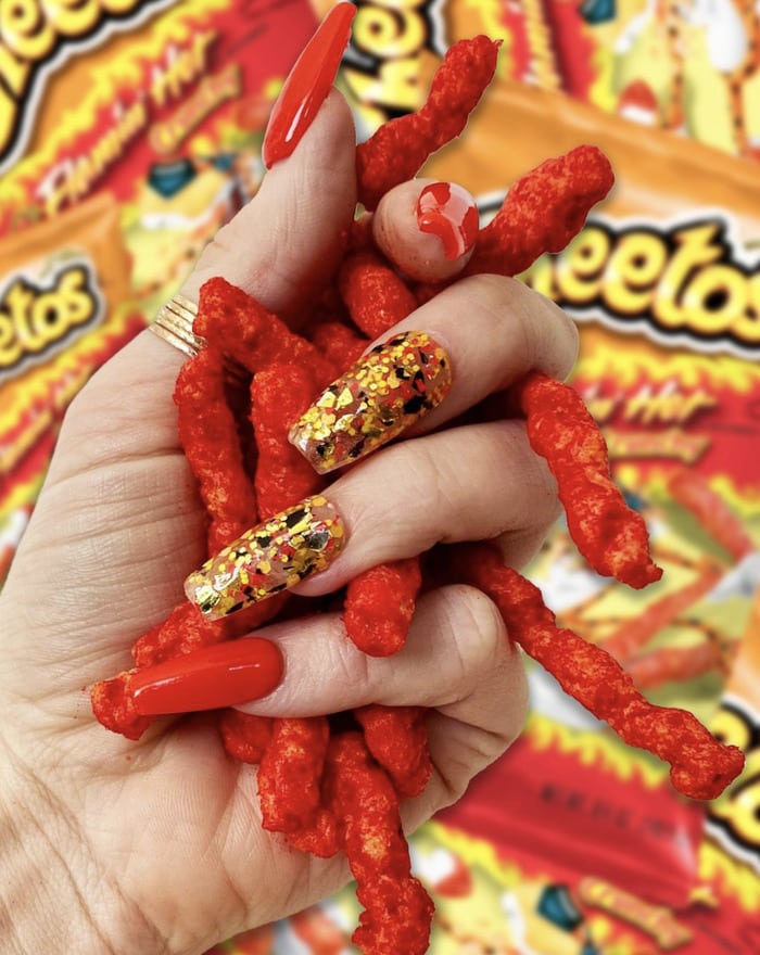 Cheetos Facts - holding flamin hot cheetos
