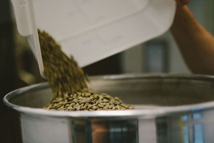 how is decaf coffee made - green beans poured into a vat