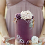 fall wedding cakes - plum frosting with frosted flowers