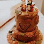 fall wedding cakes - tree stump cake with woodland creatures