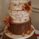 fall wedding cakes - initials cared in birch stump