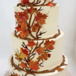 fall wedding cakes - white cake with vines and leaves