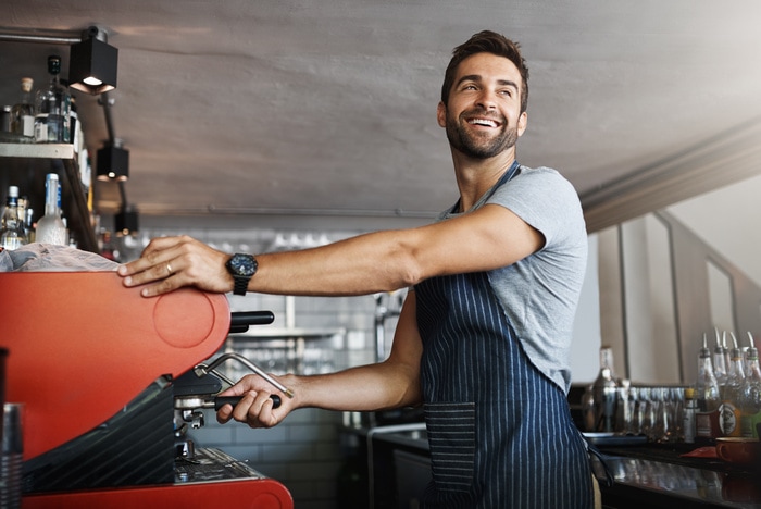 Coffee Jokes - barista making coffee at espresso machine