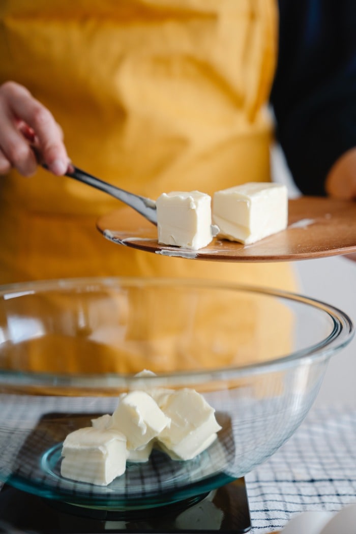 Baking Tips for Beginners - baker putting butter into bowl