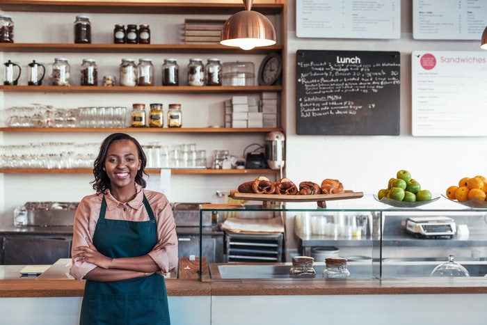 King Arthur Baking Pitchfest - African female entrepreneur standing at the counter of her bistro